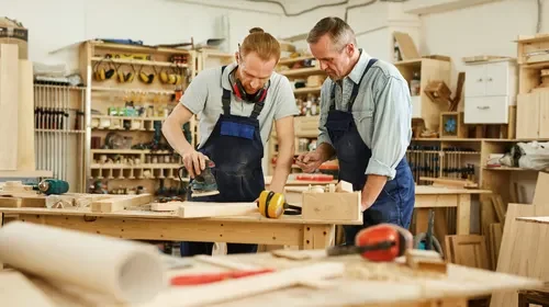 Flixpew artisans handcrafting wooden furniture in workshop, combining modern tools with traditional woodworking techniques
